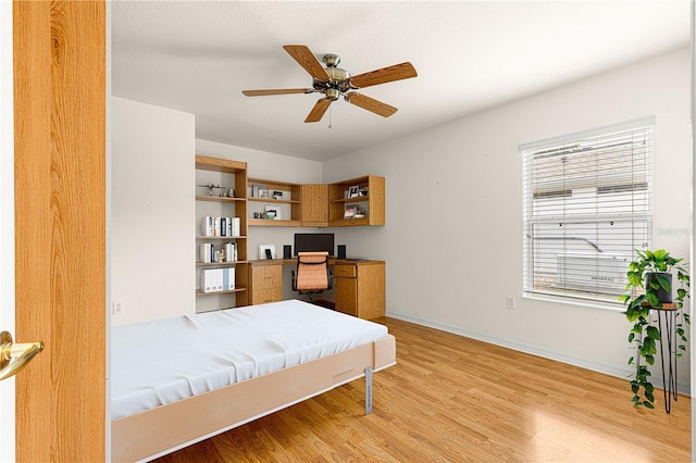 bedroom with light hardwood / wood-style floors and ceiling fan