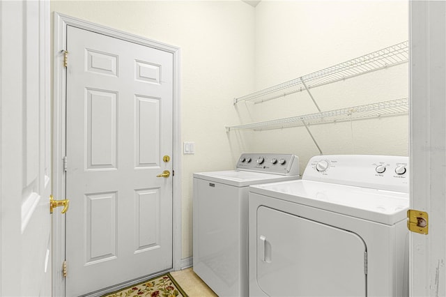 washroom featuring washer and clothes dryer