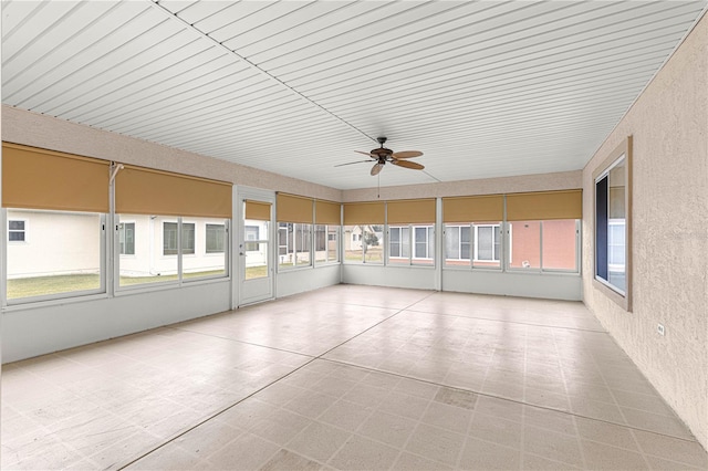 unfurnished sunroom with plenty of natural light and ceiling fan