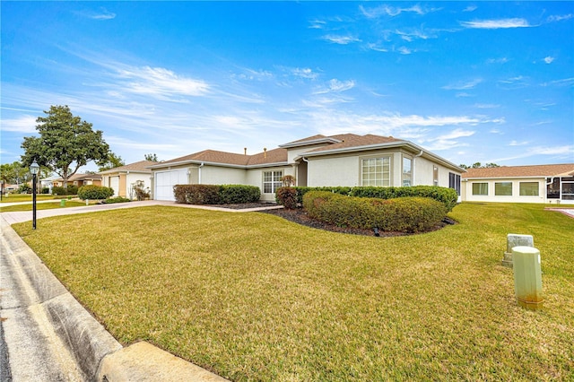 single story home with a garage and a front lawn