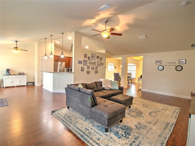 living room with ceiling fan, dark hardwood / wood-style flooring, and vaulted ceiling