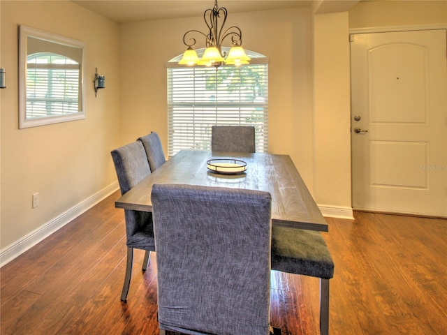 dining room featuring plenty of natural light, dark hardwood / wood-style flooring, and a notable chandelier