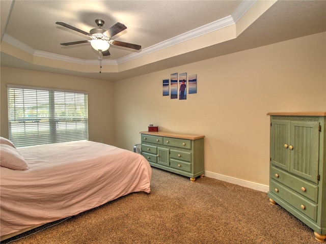 carpeted bedroom featuring crown molding, ceiling fan, and a raised ceiling