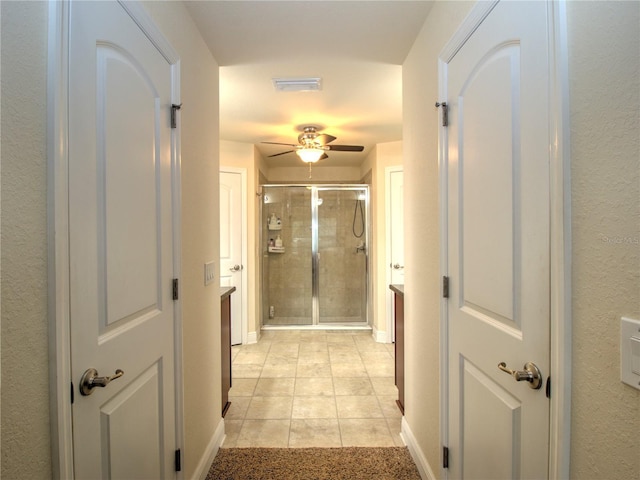 corridor featuring light tile patterned flooring