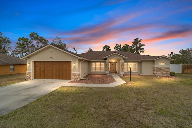 ranch-style home with a garage and a lawn