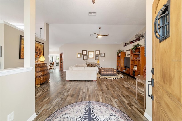 living room featuring hardwood / wood-style flooring, vaulted ceiling, and ceiling fan