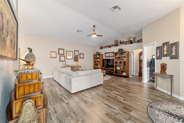 living room featuring ceiling fan, lofted ceiling, and hardwood / wood-style floors