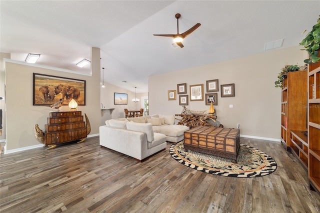 living room with dark wood-type flooring, vaulted ceiling, and ceiling fan