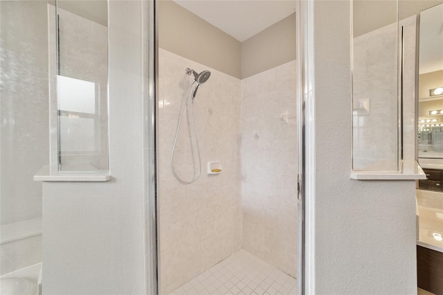 bathroom featuring vanity and a shower with shower door