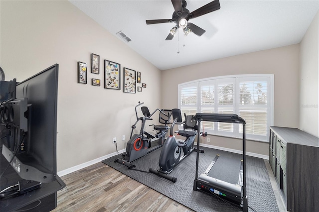 exercise room featuring hardwood / wood-style floors, vaulted ceiling, and ceiling fan