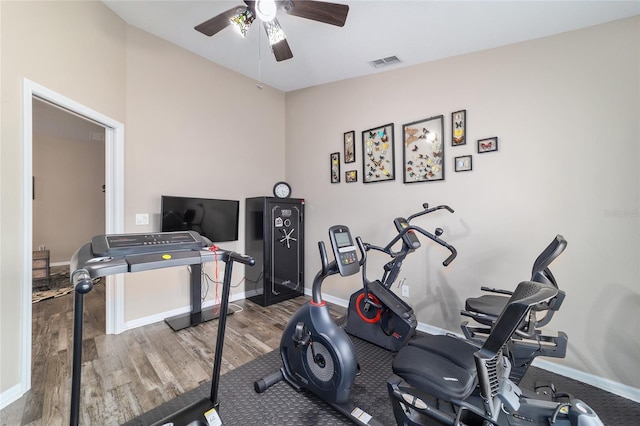 exercise area with wood-type flooring, vaulted ceiling, and ceiling fan