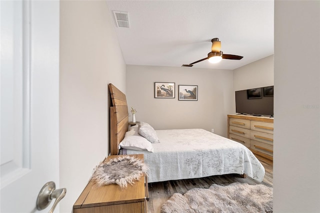 bedroom with wood-type flooring and ceiling fan