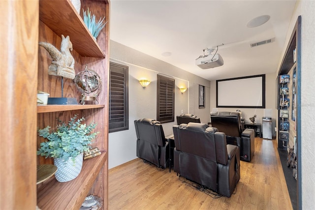 cinema room with light hardwood / wood-style flooring