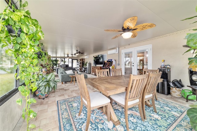 dining space with french doors, ceiling fan, and a wall mounted AC