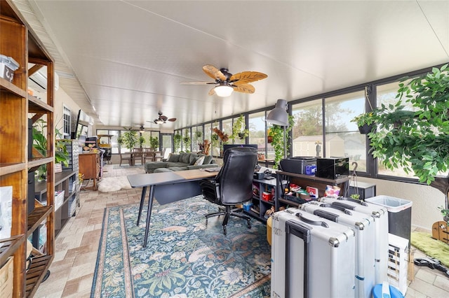 sunroom featuring ceiling fan and plenty of natural light