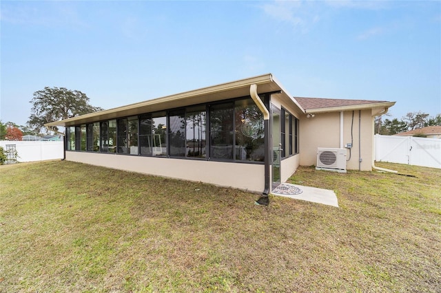 back of house with a yard, ac unit, and a sunroom