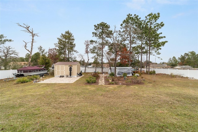 view of yard featuring a storage shed and a patio