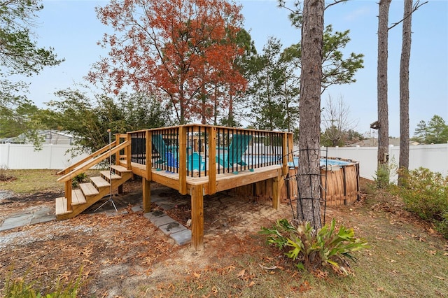 rear view of property featuring a swimming pool side deck