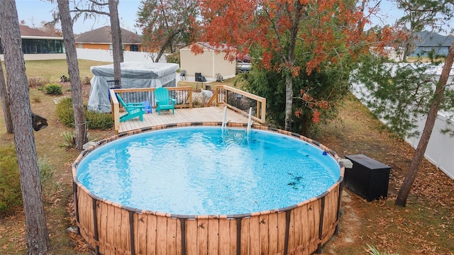 view of swimming pool with a wooden deck