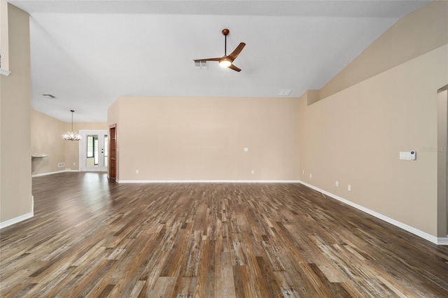 unfurnished living room featuring ceiling fan with notable chandelier, dark wood-type flooring, visible vents, baseboards, and vaulted ceiling