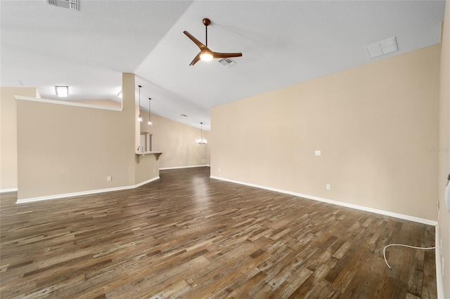 unfurnished living room with ceiling fan, dark wood-type flooring, vaulted ceiling, and visible vents