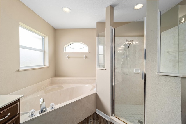 full bath with recessed lighting, a garden tub, a shower stall, and vanity