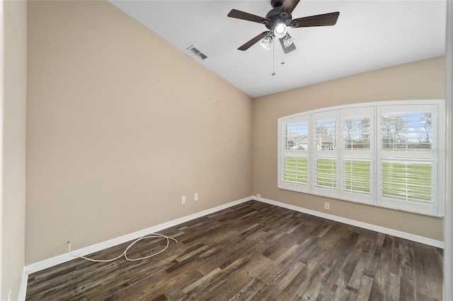 empty room with baseboards, visible vents, dark wood finished floors, and a ceiling fan