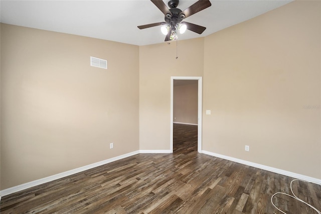 spare room with visible vents, dark wood finished floors, baseboards, and ceiling fan