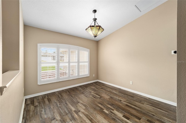 unfurnished room with dark wood-style floors and baseboards