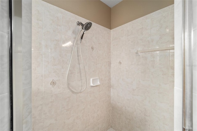 bathroom with a tile shower