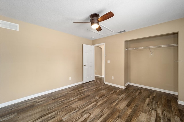 unfurnished bedroom featuring a closet, visible vents, dark wood finished floors, and baseboards