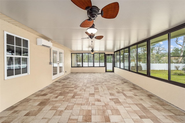 unfurnished sunroom featuring a wall unit AC and a ceiling fan