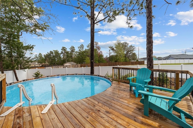 view of pool with a deck, a fenced backyard, and a fenced in pool