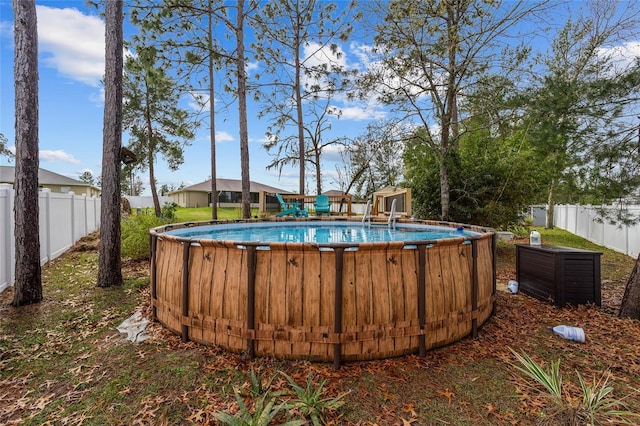 view of pool featuring a fenced backyard and a fenced in pool