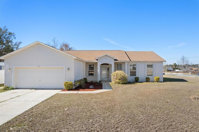 ranch-style home featuring a garage and a front lawn