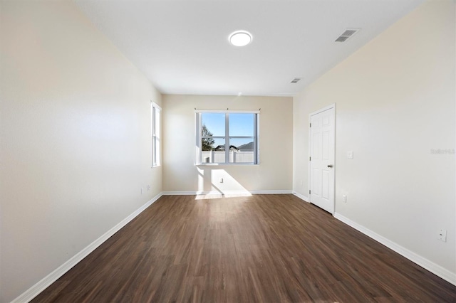 empty room featuring dark wood-type flooring