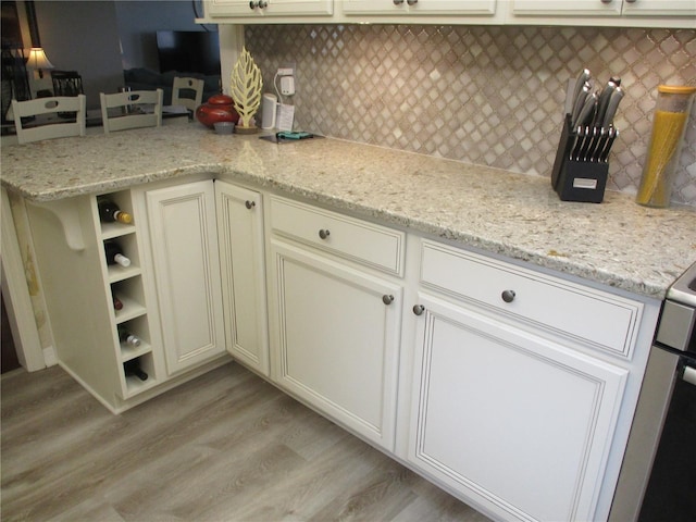 kitchen featuring open shelves, light stone counters, and backsplash