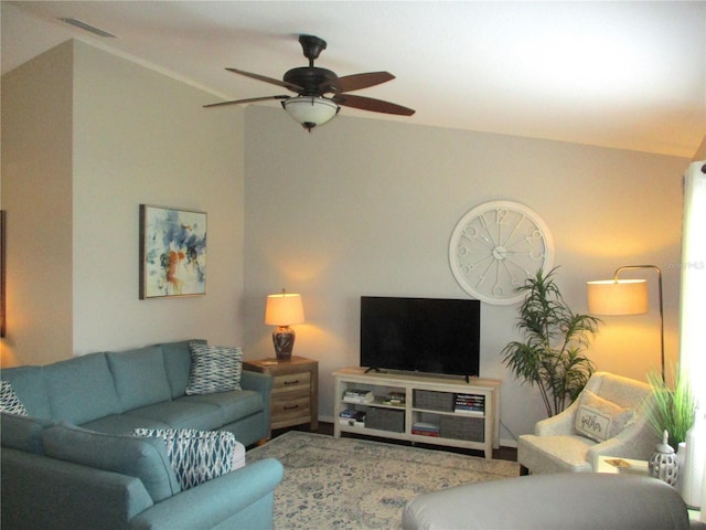 living area featuring vaulted ceiling, visible vents, and ceiling fan