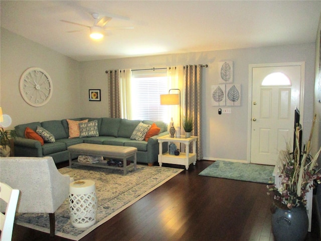 living room with dark wood finished floors, baseboards, and ceiling fan