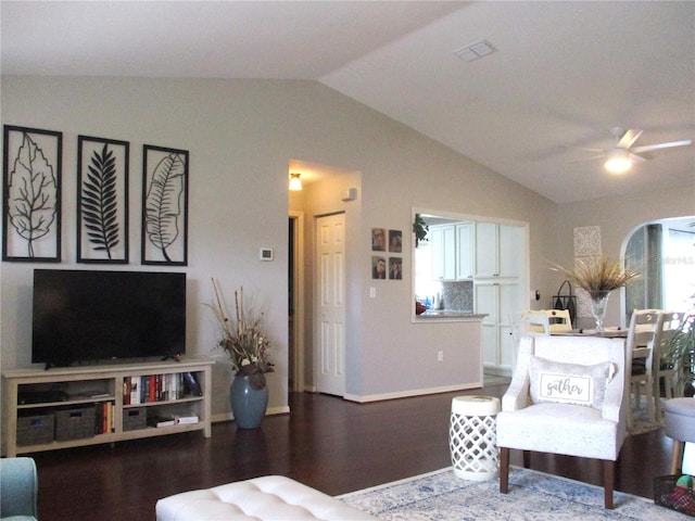 living room with lofted ceiling, ceiling fan, baseboards, and wood finished floors