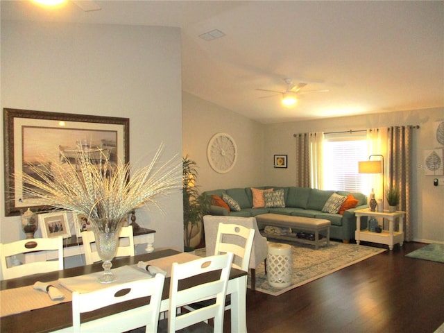 living room featuring vaulted ceiling, dark wood-style flooring, and a ceiling fan