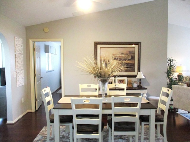 dining area with vaulted ceiling, wood finished floors, and baseboards