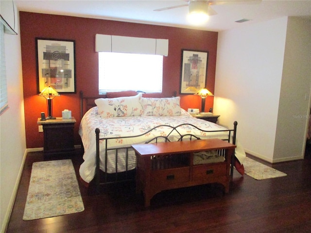 bedroom featuring visible vents, baseboards, ceiling fan, and dark wood-style flooring