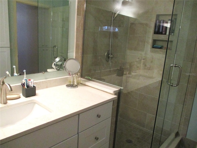 bathroom with vanity and a shower stall