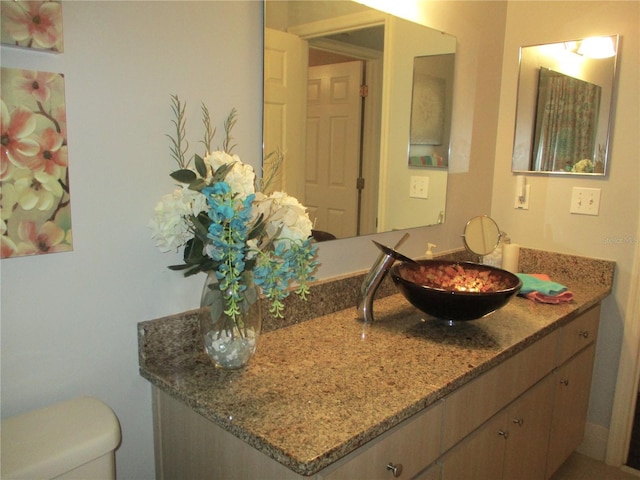 half bathroom with vanity and toilet