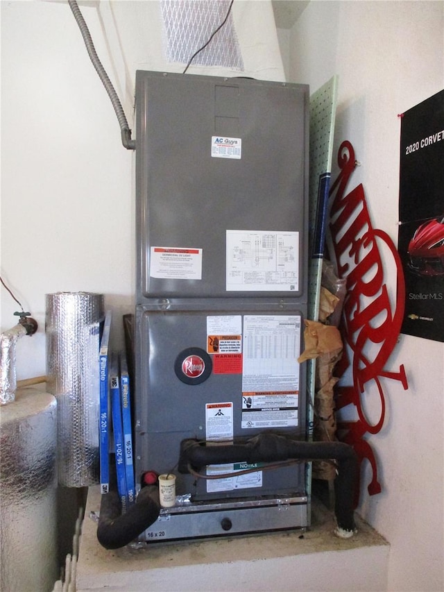 utility room featuring heating unit