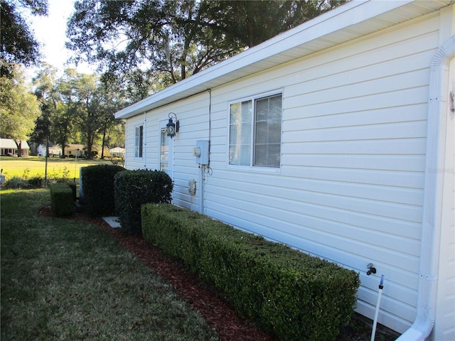 view of property exterior with a yard