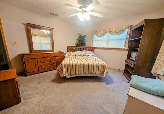 bedroom with light carpet, a textured ceiling, and ceiling fan