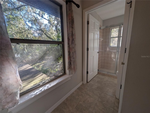 corridor featuring light tile patterned floors