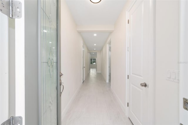 corridor with light tile patterned floors